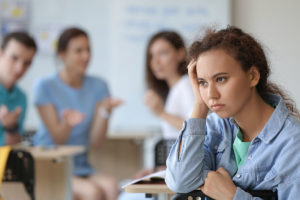 a teen resists reacting to her bullies in class
